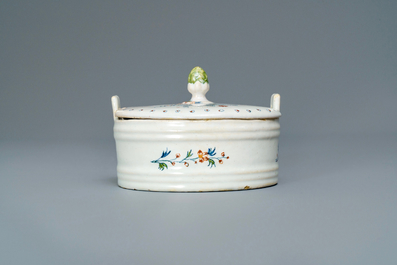 A polychrome Brussels faience '&agrave; la haie fleurie' butter tub and cover, 18th C.